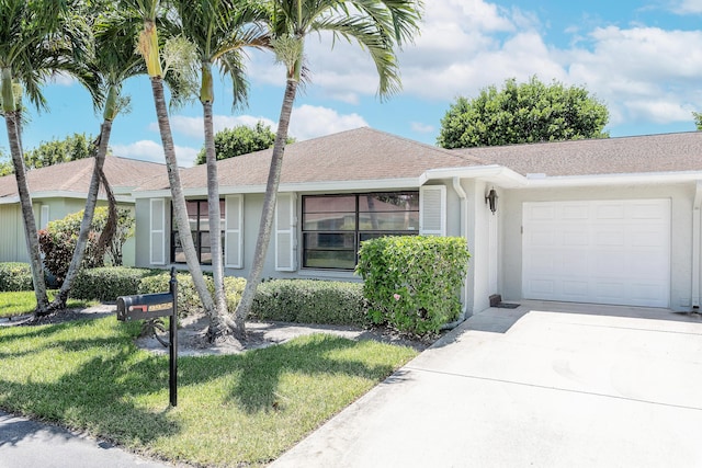 ranch-style house with a front yard and a garage