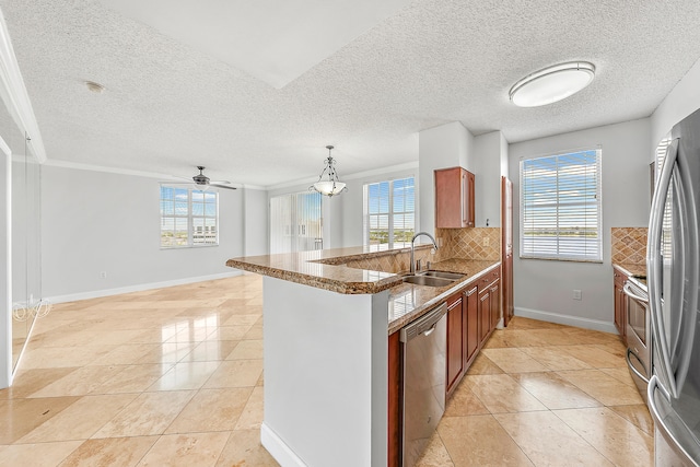 kitchen featuring stainless steel appliances, a healthy amount of sunlight, sink, light tile patterned floors, and backsplash