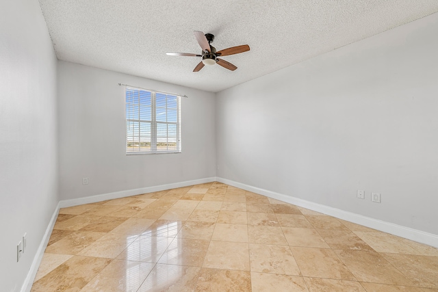 empty room with a textured ceiling, light tile patterned floors, and ceiling fan