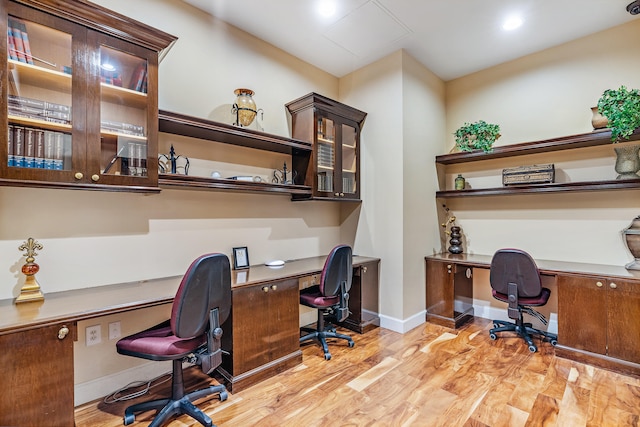 office featuring light hardwood / wood-style floors and built in desk