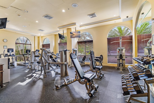 gym featuring a tray ceiling