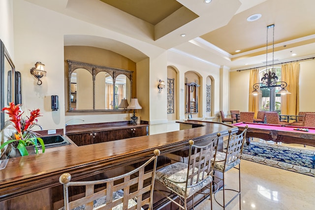 dining room featuring tile patterned flooring and a raised ceiling