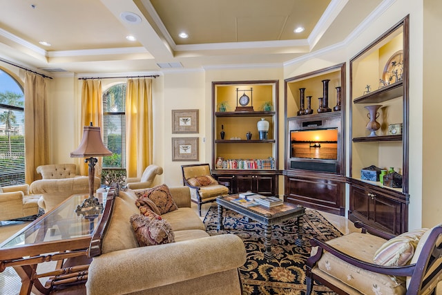 living room with a healthy amount of sunlight, a raised ceiling, and ornamental molding