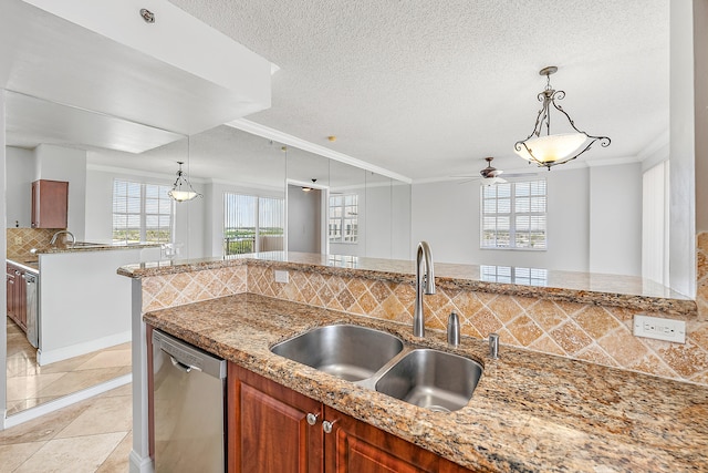 kitchen featuring sink, pendant lighting, backsplash, stainless steel dishwasher, and crown molding