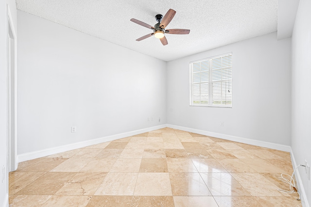 tiled empty room with a textured ceiling and ceiling fan