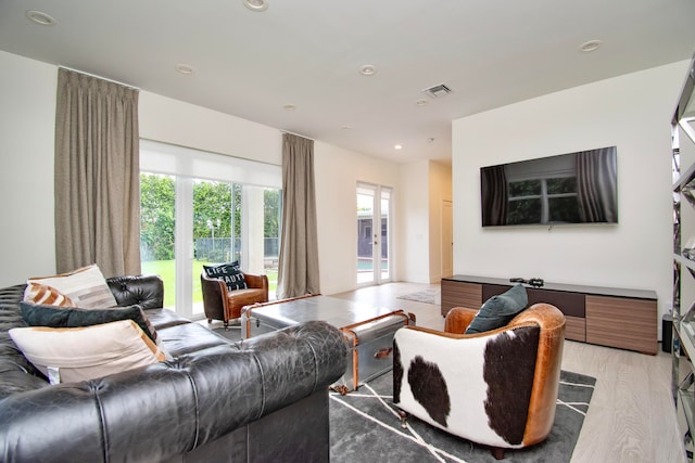 living room featuring light hardwood / wood-style flooring and french doors