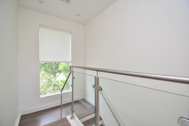 stairs with wood-type flooring