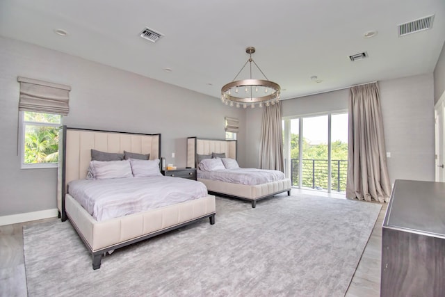 bedroom featuring access to outside and light hardwood / wood-style floors