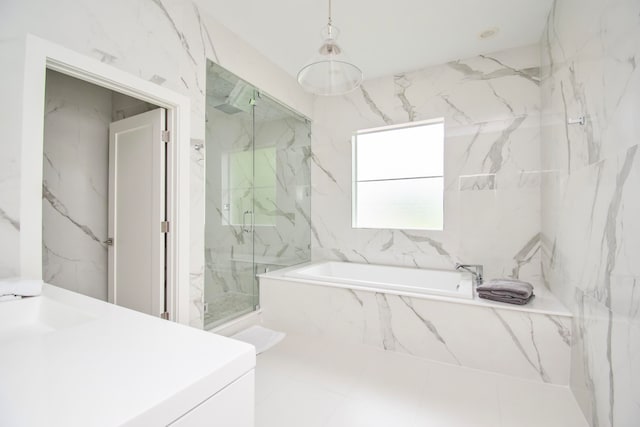 bathroom featuring plus walk in shower, tile walls, tile patterned flooring, and vanity