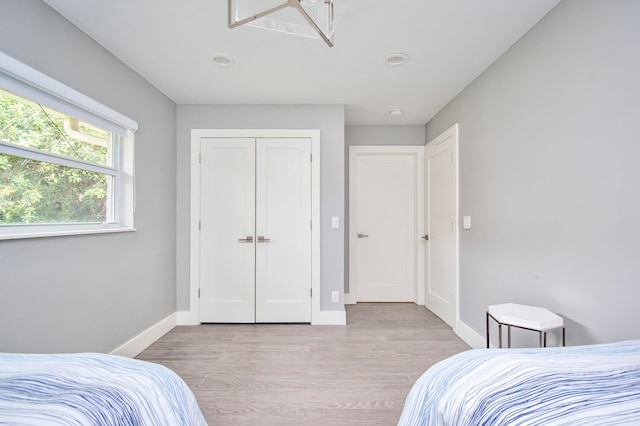 bedroom featuring light wood-type flooring and a closet