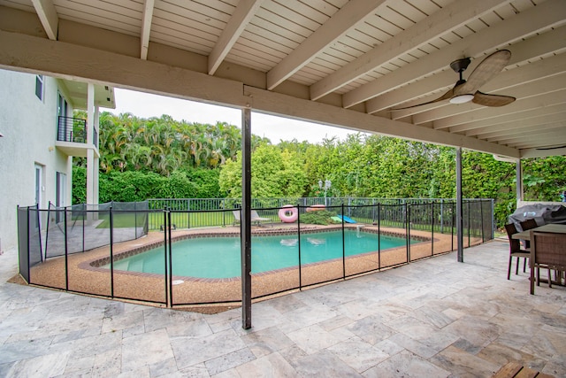 view of swimming pool with ceiling fan, area for grilling, and a patio area