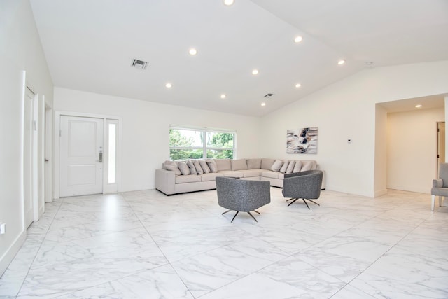 living room with lofted ceiling and light tile patterned flooring