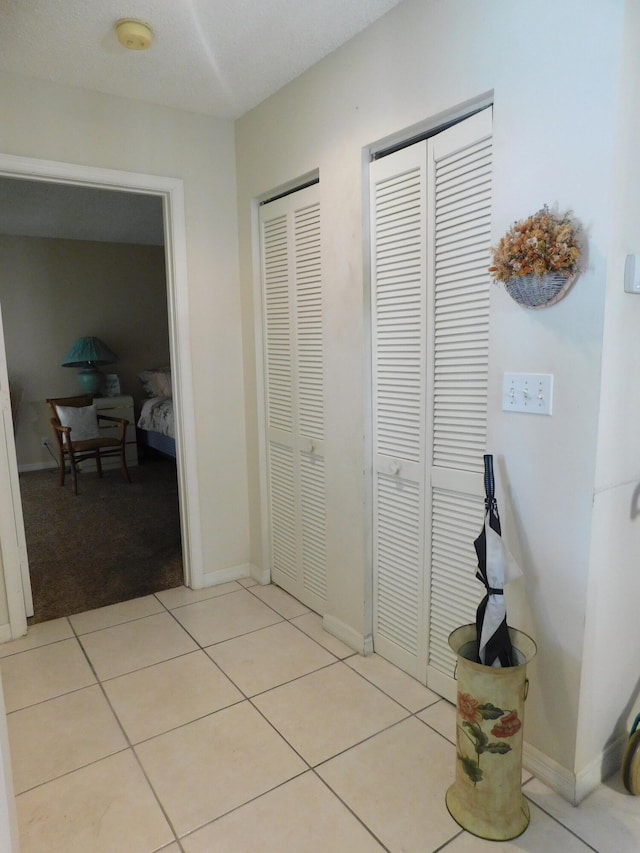 corridor with light tile patterned flooring