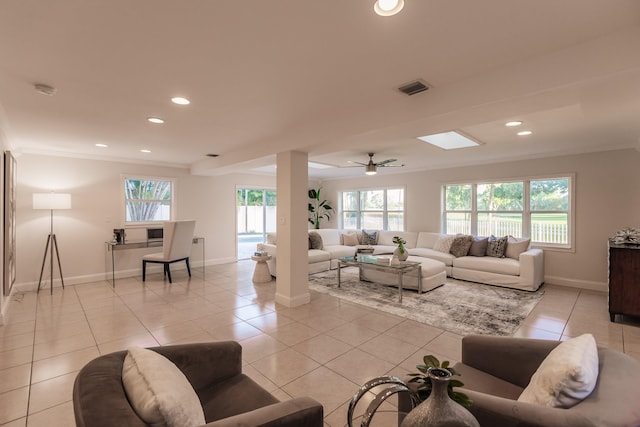 living room featuring ceiling fan, crown molding, and light tile patterned flooring