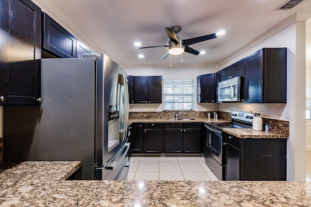 kitchen with ceiling fan, sink, stainless steel appliances, stone countertops, and light tile patterned flooring