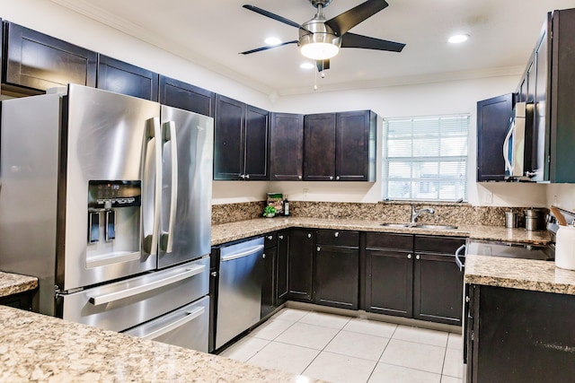 kitchen with crown molding, sink, light tile patterned flooring, and stainless steel appliances