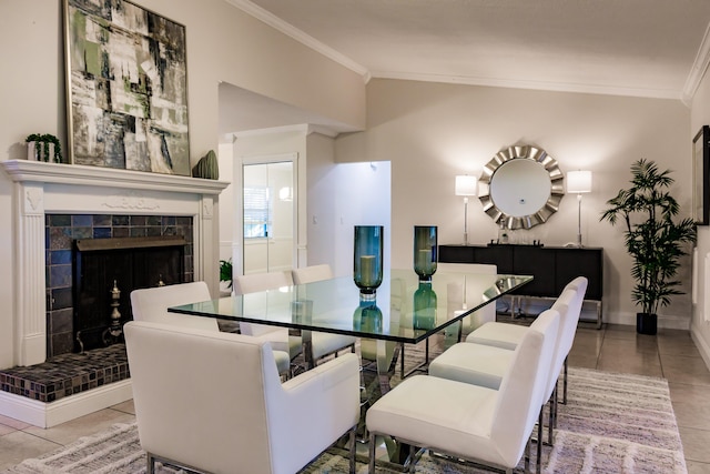 tiled dining space with a tile fireplace and crown molding