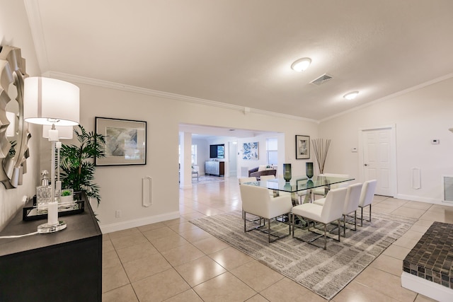 dining room featuring a textured ceiling, light tile patterned floors, crown molding, and vaulted ceiling