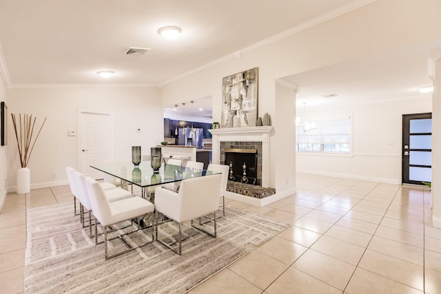 dining room with light tile patterned floors and ornamental molding