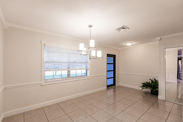 tiled spare room featuring crown molding and a chandelier