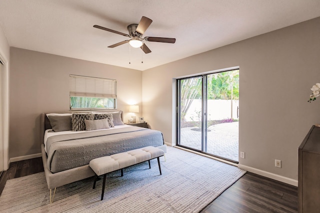 bedroom featuring access to exterior, dark hardwood / wood-style floors, and ceiling fan