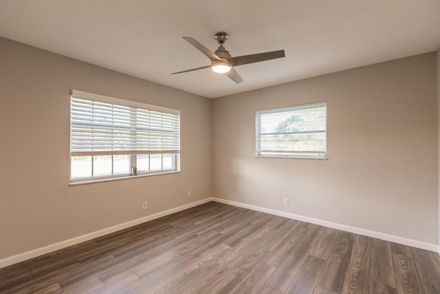 empty room with dark hardwood / wood-style flooring and ceiling fan