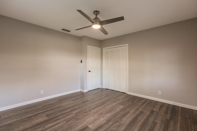 unfurnished bedroom with a closet, dark hardwood / wood-style floors, and ceiling fan