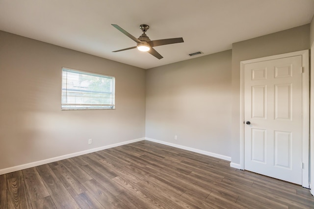 spare room with ceiling fan and dark hardwood / wood-style floors