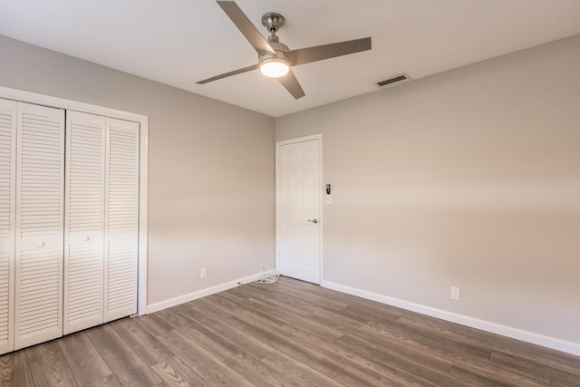 unfurnished bedroom with a closet, ceiling fan, and hardwood / wood-style flooring