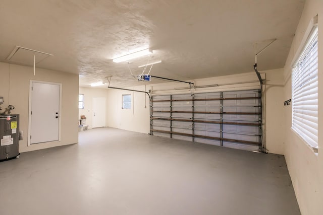 garage featuring a garage door opener and water heater