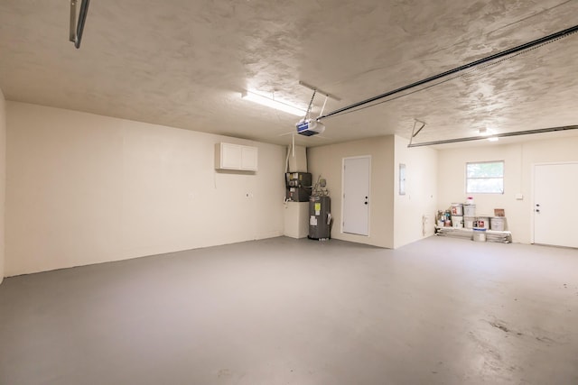 garage featuring a garage door opener and water heater