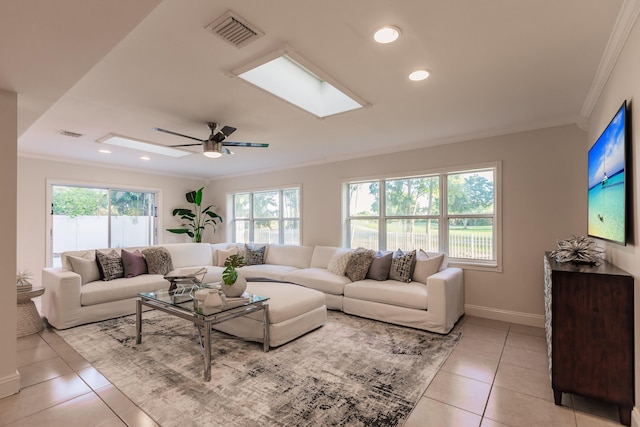 tiled living room featuring ceiling fan and crown molding