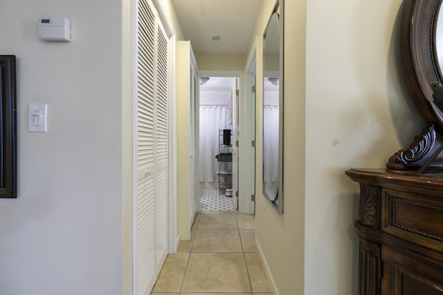 hall with light tile patterned floors