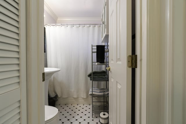 bathroom featuring toilet, ornamental molding, and shower / bathtub combination with curtain