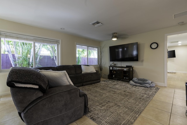 tiled living room with ceiling fan