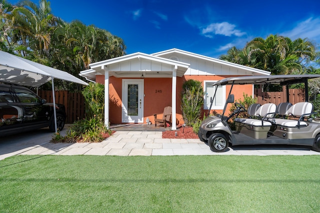 view of front of property with a carport and a front yard