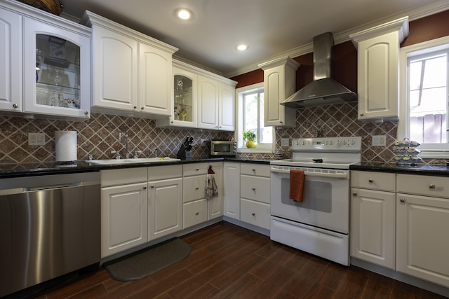 kitchen featuring white range with electric cooktop, dishwasher, sink, tasteful backsplash, and wall chimney range hood