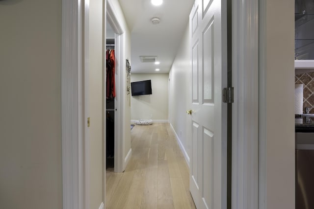 corridor featuring light hardwood / wood-style floors