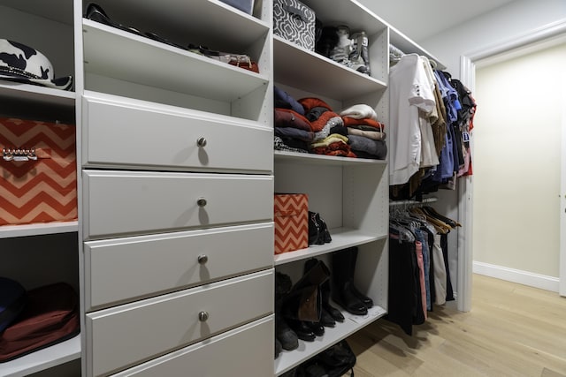 spacious closet with light hardwood / wood-style floors