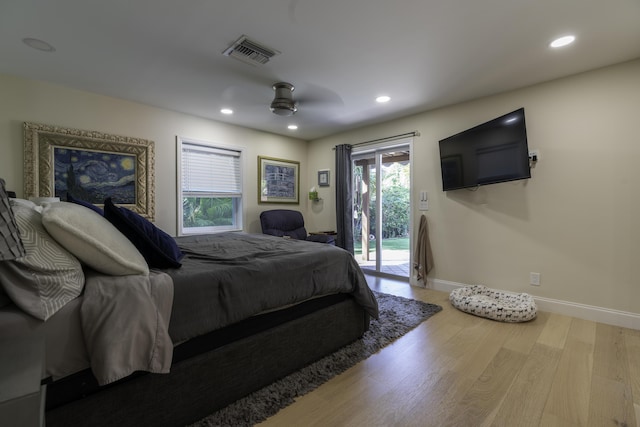 bedroom with hardwood / wood-style floors, access to exterior, and ceiling fan