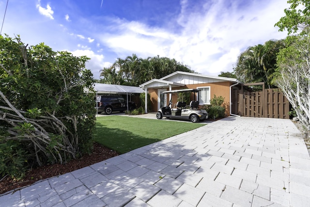 view of front facade with a front lawn and a carport