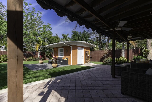 view of patio / terrace featuring ceiling fan and an outdoor structure