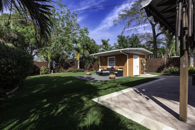 view of yard featuring a patio area, an outbuilding, and an outdoor hangout area