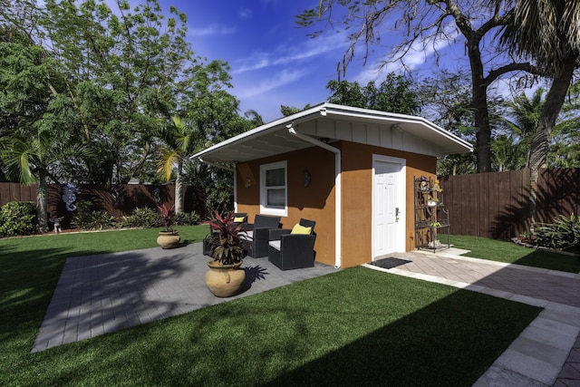 view of outbuilding featuring a lawn