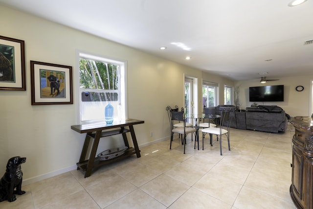 tiled dining space with a healthy amount of sunlight