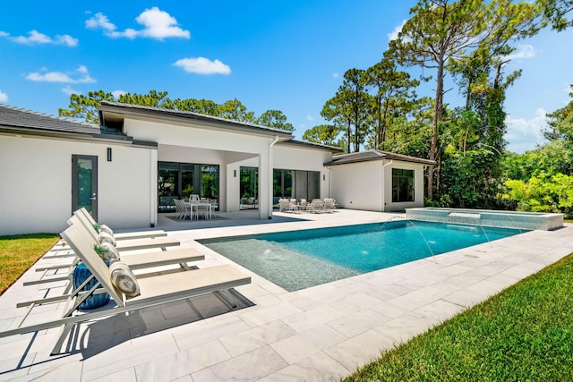 view of pool with pool water feature and a patio