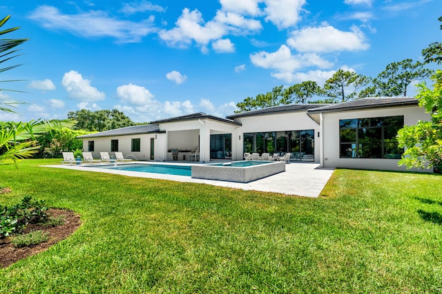 rear view of house with a patio and a yard