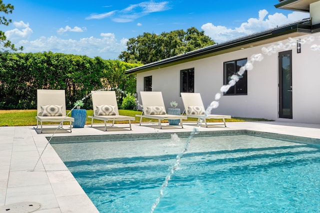 view of pool featuring pool water feature and a patio area