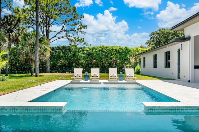 view of pool with pool water feature and a patio area