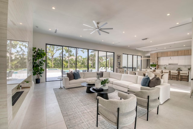 tiled living room with ceiling fan